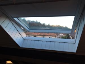 a skylight in a house with a window at Cozy Attica - With Every Comfort - Berne in Liebefeld