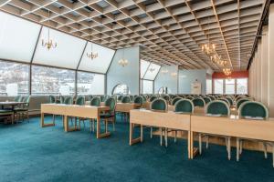 an empty conference room with tables and chairs at Oppdal Turisthotell in Oppdal