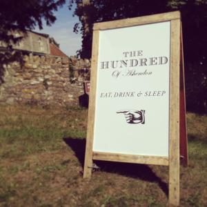 a sign for the huttied of hamiltonledgedledgedledgedledgedledgedledged at The Hundred of Ashendon in Waddesdon
