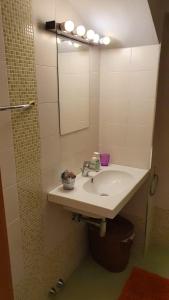 a bathroom with a sink and a mirror at Appartamento Il GIRASOLE in Scarperia