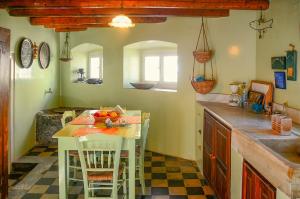 a kitchen with a table and chairs in a kitchen at Villa Spetses in Spetses