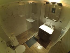 a bathroom with a shower and a toilet and a sink at Chrysafenia & Leandros Downtown in Kavála +17 photos