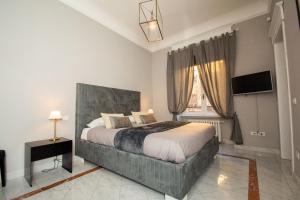 Ένα ή περισσότερα κρεβάτια σε δωμάτιο στο Compasso Suites