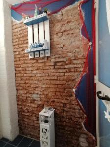 a room with a brick wall with an american flag at Blue sea in Aci Castello