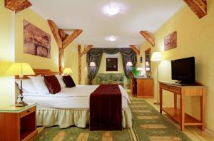 a bedroom with a bed and a flat screen tv at The Council in Sibiu