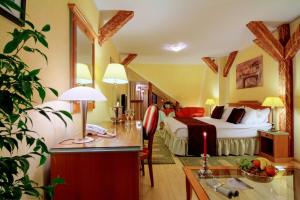 a hotel room with a bed and a desk at The Council in Sibiu