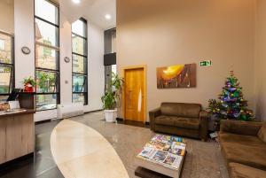 a living room with a christmas tree and a couch at Tri Hotel & Flat Caxias in Caxias do Sul