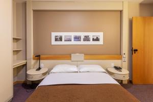 Krevet ili kreveti u jedinici u objektu Tri Hotel & Flat Caxias