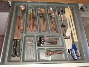 a tray filled with utensils and utensils at Apartment am Park in Duisburg