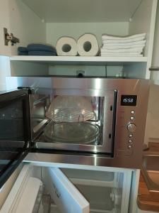 a toaster oven with a pan inside of it at Apartment am Park in Duisburg +18 photos