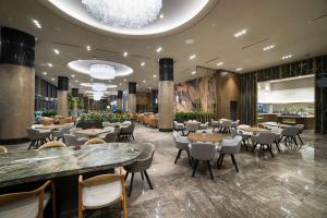 a restaurant with tables and chairs in a lobby at Radisson Collection Hotel, Vadistanbul in Istanbul