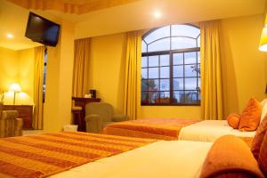En eller flere senge i et værelse på Hotel Monteolivos