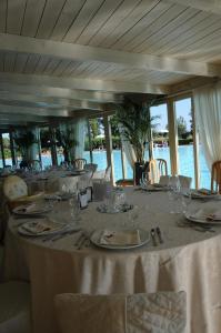 a table with plates and wine glasses on it at Cosmopolitan Golf & Beach Resort in Tirrenia