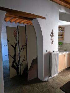 a bathroom with a door with a tree mural on the wall at Villa Filitsa in Platis Gialos +22 photos