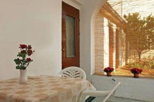 a dining room with a table and chairs and a window at Apartment Quiet Getaway in Koromačno