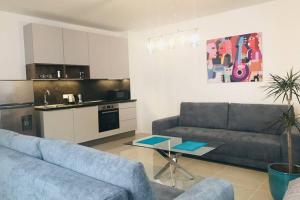a living room with two couches and a kitchen at Apartment right in the center of Brno in Brno