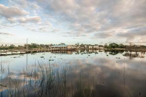 a large body of water with a dock and buildings at Days Inn & Suites by Wyndham Lake Okeechobee in Okeechobee