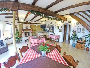 a living room with a table and chairs and a fireplace at Pension Nea Marin in Măgura