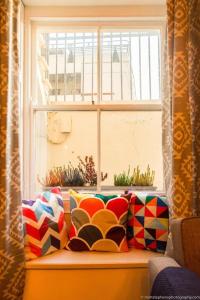 a window sill with a couch in front of a window at Seafront Apartment with Garden in Brighton & Hove