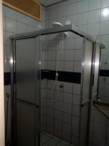 a shower with a shower head in a bathroom at Hotel Nacional Service in Goiânia