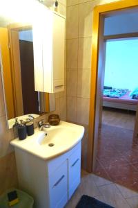 La salle de bains est pourvue d'un lavabo et d'un miroir. dans l'établissement Apartment Munida, à Medulin