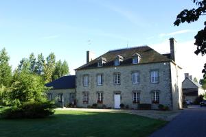 a large stone house with a grass yard at Domaine Utah Beach - Le Grand Hard in Sainte-Marie-du-Mont