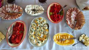 a table with many plates of food on it at Hotelik Krakowiak in Jarosław