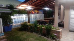 a patio with a white fence and a wooden bench at POUSADA LOS AMIGOS CAMPECHE in Florianópolis