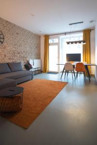 ein Wohnzimmer mit einem Sofa und einem Tisch in der Unterkunft Gemütliches Appartment südlich vom Wöhrder See in Nürnberg