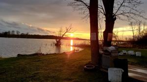 a sunset over a lake with the sun setting at Riverview Motel in Dunnville