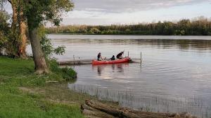 two people and a dog in a boat on a lake at Riverview Motel in Dunnville