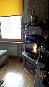 a living room with a fireplace and a christmas tree at Matija LUX Konaci in Zlatibor