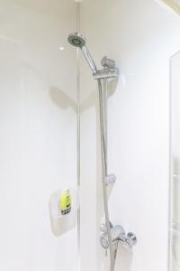 a shower with a shower head in a bathroom at Bedzzz - Booklovers Dream in Preston