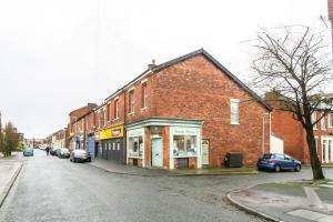 a brick building on the side of a street at Bedzzz - Booklovers Dream in Preston