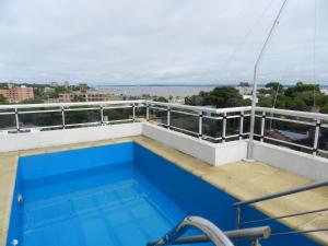 a swimming pool on the balcony of a building at El Departamento de los Abuelos in Posadas