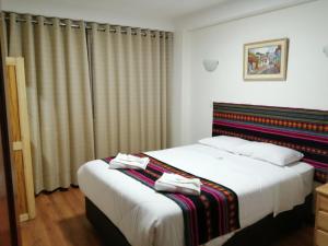 Postel nebo postele na pokoji v ubytování Hostal Casona Arrambide