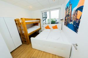 a room with a white couch and a bunk bed at City Apartment Reeperbahn Hamburg in Hamburg