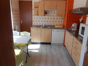 a kitchen with a sink and a table in it at Villa NORICA in Bordezac