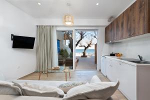 a kitchen and living room with a couch and a table at Stegna Dream in Archangelos
