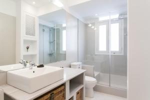 a white bathroom with a sink and a shower at Athens Heritage Suite in Athens +21 photos