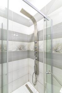 a shower with a glass door in a bathroom at Apartment Queen in Sibiu