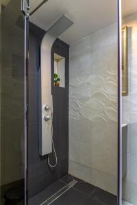 a shower with a glass door in a bathroom at Apartment Queen Bridge in Sibiu