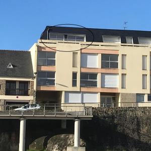 a building with a bridge and a car on a bridge at L'Imprenable vue mer in Crozon