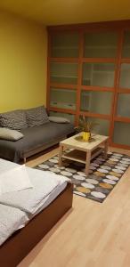 ブダペストにあるObuda Apartmentのベッド2台とコーヒーテーブルが備わる客室です。