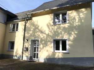 a white house with two windows on the side at Ferienhaus an der Bäderstraße in Pohl