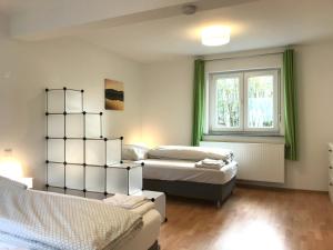 a bedroom with two beds and a window at Ferienhaus an der Bäderstraße in Pohl