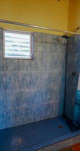a bathroom with a shower with a window at The Tranquila Caye- Gold Standard Certified in Caye Caulker