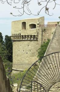 a building with a staircase in front of a tower at Corsomessina64 in Crotone