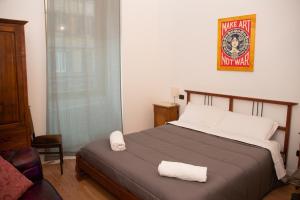 een slaapkamer met een bed met twee handdoeken erop bij Dillo Suites in Rome