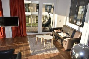 a living room with a couch and a table at LOFT Port Marina 26 in Bremerhaven